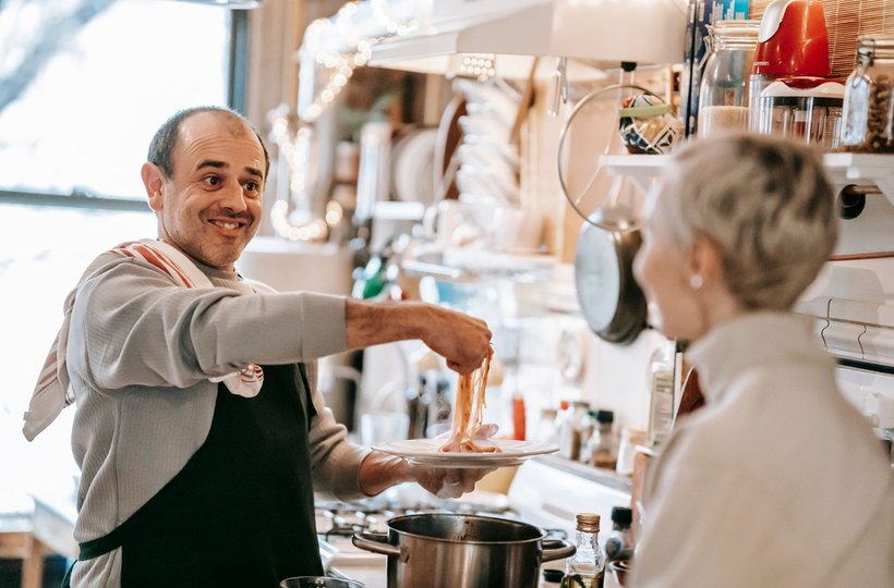 A couple cooking together in the kitchen
