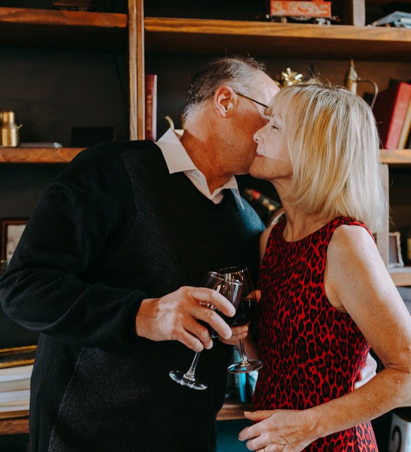 A couple celebrating at home with a glass of wine